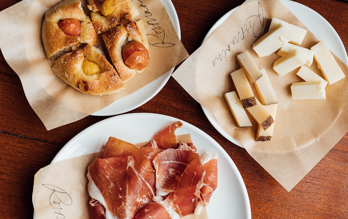 plates of charcuterie, cheese and focaccia